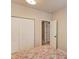 Bedroom view showcasing double closet, neutral walls, and doorway leading to another room at 5036 Maplecliff Dr, Sugar Hill, GA 30518
