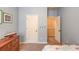 Bright bedroom boasts light blue walls, white trim and doors, and features convenient closet and storage spaces at 5036 Maplecliff Dr, Sugar Hill, GA 30518