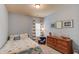 Comfortable bedroom featuring light blue walls, plush carpet, and a decorative dresser with ship model at 5036 Maplecliff Dr, Sugar Hill, GA 30518