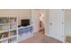 Bedroom with a built-in bookshelf and easy access to the hallway and closet at 5036 Maplecliff Dr, Sugar Hill, GA 30518