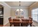 Dining room features a wooden table with seating for six, complemented by modern decor at 5036 Maplecliff Dr, Sugar Hill, GA 30518