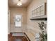 Entryway featuring hardwood floors, a white bench, and a decorative shelf, creating a welcoming atmosphere at 5036 Maplecliff Dr, Sugar Hill, GA 30518