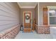 Inviting front porch with brick accents and a decorative wreath adorning the front door at 5036 Maplecliff Dr, Sugar Hill, GA 30518