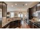 Well-equipped kitchen featuring granite countertops, stainless steel appliances, and dark wood cabinetry at 5036 Maplecliff Dr, Sugar Hill, GA 30518