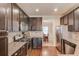 Spacious kitchen with stainless steel appliances, dark cabinets, and hardwood flooring, providing a modern aesthetic at 5036 Maplecliff Dr, Sugar Hill, GA 30518