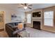 Comfortable living room with a fireplace and large windows offering plenty of natural light at 5036 Maplecliff Dr, Sugar Hill, GA 30518