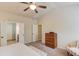Bright main bedroom featuring a ceiling fan, tray ceiling, ensuite bathroom and neutral color palette at 5036 Maplecliff Dr, Sugar Hill, GA 30518