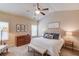 Comfortable primary bedroom featuring a plush bed, dresser, and natural light from windows at 5036 Maplecliff Dr, Sugar Hill, GA 30518