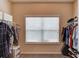 Walk-in closet with carpet flooring and clothing racks on both sides of the room at 5036 Maplecliff Dr, Sugar Hill, GA 30518