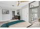 Bright bedroom featuring a ceiling fan, a large door to a patio, and a walk-in closet at 250 Park Avenue West Nw # 313, Atlanta, GA 30313