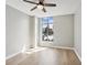 A well-lit bedroom with hardwood floors, a large window, and a ceiling fan at 250 Park Avenue West Nw # 313, Atlanta, GA 30313