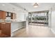 Bright living area featuring wood floors, a partial kitchen view, and access to a large window-lined balcony space at 250 Park Avenue West Nw # 313, Atlanta, GA 30313