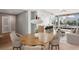 Staged open-concept living area with hardwood floors, stylish dining set, and modern kitchen with breakfast bar at 250 Park Avenue West Nw # 313, Atlanta, GA 30313