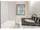 Stylish bathroom featuring subway tile, updated fixtures, and black countertop at 2695 Peeler Rd, Dunwoody, GA 30360
