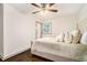 Cozy bedroom with ceiling fan, natural light, and hardwood floors at 2695 Peeler Rd, Dunwoody, GA 30360