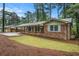 Beautiful brick home featuring a long carport, shutters and a well-manicured lawn at 2695 Peeler Rd, Dunwoody, GA 30360