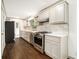 Updated kitchen with white cabinets, stainless steel appliances, and a subway tile backsplash at 2695 Peeler Rd, Dunwoody, GA 30360