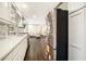 Bright kitchen featuring modern white cabinets, stainless steel appliances, and dark wood floors at 2695 Peeler Rd, Dunwoody, GA 30360