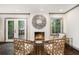 Elegant living room with a fireplace, French doors, and sophisticated decor at 2695 Peeler Rd, Dunwoody, GA 30360