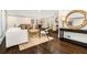Open living space featuring hardwood floors, stylish furniture, and a view into the dining area at 2695 Peeler Rd, Dunwoody, GA 30360