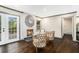 Living room with a painted brick fireplace, French doors, and stylish decor at 2695 Peeler Rd, Dunwoody, GA 30360