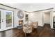 Cozy living room features hardwood floors, a brick fireplace, and access to the backyard at 2695 Peeler Rd, Dunwoody, GA 30360
