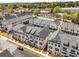 An aerial view of newly constructed townhomes featuring modern design, grey roofs, and manicured lawns at 3980 Allegretto Cir, Atlanta, GA 30339