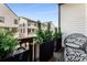 Cozy balcony with stylish outdoor seating, decorative plants, and views of neighboring homes at 3980 Allegretto Cir, Atlanta, GA 30339