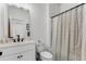 Cozy bathroom featuring a single vanity, a framed mirror, and a tub with a shower curtain at 3980 Allegretto Cir, Atlanta, GA 30339