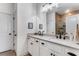 Bright bathroom featuring a double vanity, sleek black hardware, and a glass-enclosed shower at 3980 Allegretto Cir, Atlanta, GA 30339