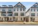Charming three-story townhome with brick and siding exterior and manicured landscaping at 3980 Allegretto Cir, Atlanta, GA 30339