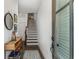 Inviting foyer showcasing staircase, modern decor, hardwood floors, and natural light through a front door window at 3980 Allegretto Cir, Atlanta, GA 30339