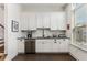 Modern kitchen features sleek white cabinets, dark countertops, and stainless steel appliances at 3980 Allegretto Cir, Atlanta, GA 30339