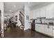 Modern kitchen featuring white cabinets, stainless steel appliances, dark countertops, and open layout with hardwood floors at 3980 Allegretto Cir, Atlanta, GA 30339