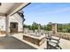 Outdoor patio with stone fire pit, comfortable seating, and scenic views of surrounding trees at 3980 Allegretto Cir, Atlanta, GA 30339