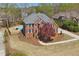Aerial view of a brick home with mature landscaping, a pool, and a well-maintained yard at 880 Crossfire Nw Rdg, Marietta, GA 30064