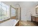 Bright bathroom featuring a tub, a tiled shower, and elegant finishes at 880 Crossfire Nw Rdg, Marietta, GA 30064