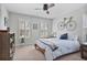 Cozy bedroom features a ceiling fan, neutral walls, and natural light from the shuttered windows at 880 Crossfire Nw Rdg, Marietta, GA 30064