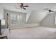 Large bonus room with ample natural light, neutral colors, and dual ceiling fans at 880 Crossfire Nw Rdg, Marietta, GA 30064