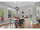 Sunny breakfast nook with a modern chandelier and views of the trees and deck at 880 Crossfire Nw Rdg, Marietta, GA 30064