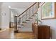 Entryway features hardwood floors, staircase with iron spindles, and natural light at 880 Crossfire Nw Rdg, Marietta, GA 30064