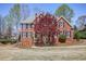 Charming two-story brick home featuring a manicured lawn and beautifully landscaped front yard at 880 Crossfire Nw Rdg, Marietta, GA 30064