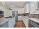 Updated kitchen with stainless appliances, granite countertops, tile backsplash, and white cabinets at 880 Crossfire Nw Rdg, Marietta, GA 30064
