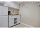 Small kitchenette area featuring a refrigerator, coffee maker, and storage cabinets at 880 Crossfire Nw Rdg, Marietta, GA 30064