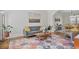 Bright living room featuring a gray sofa, area rug, hardwood floors, and a doorway to the dining room at 880 Crossfire Nw Rdg, Marietta, GA 30064