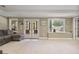 Spacious living room with ample natural light, a gray sectional sofa, and access to the outdoors at 880 Crossfire Nw Rdg, Marietta, GA 30064