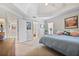 Light-filled main bedroom featuring a tray ceiling, ensuite, and neutral décor at 880 Crossfire Nw Rdg, Marietta, GA 30064