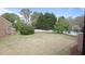 Large, grassy backyard with partial fencing, mature trees and lush landscaping at 1754 Heights Nw Cir # 11, Kennesaw, GA 30152