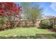 Fenced backyard with mature trees, lush landscaping, and a well-maintained lawn at 1754 Heights Nw Cir # 11, Kennesaw, GA 30152