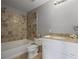 Neutral bathroom featuring a tub with tile surround and vanity with stone countertop at 1754 Heights Nw Cir # 11, Kennesaw, GA 30152
